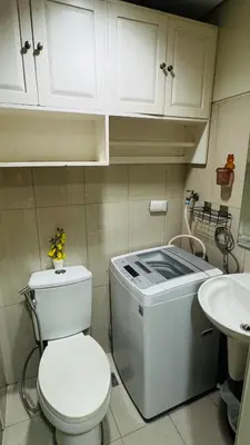 a bathroom with a toilet and a sink at Dawn Haven Staycation in Manila