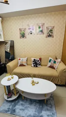 a living room with a couch and two tables at Dawn Haven Staycation in Manila