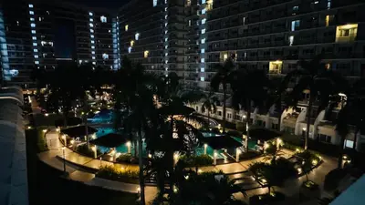 a view of a building with a pool at night at Dawn Haven Staycation in Manila