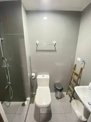 a bathroom with a toilet and a sink at Air Residences in Manila