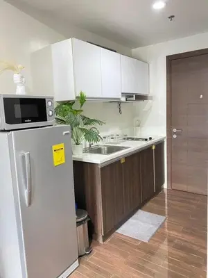 a kitchen with a refrigerator and a sink at Air Residences in Manila