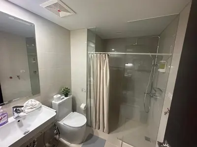 a bathroom with a shower and a toilet and a sink at TravelersChoiceCondominium in Manila
