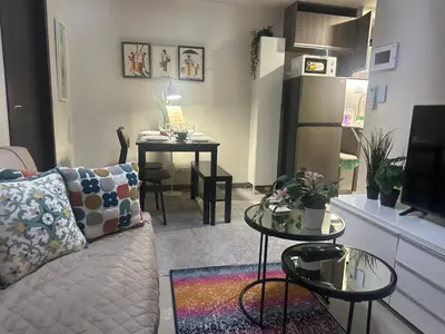 a living room with a couch and a table at TravelersChoiceCondominium in Manila