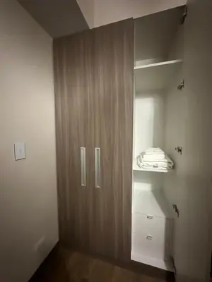 a closet with a wooden door in a room at TravelersChoiceCondominium in Manila