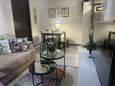 a living room with two tables and a couch at TravelersChoiceCondominium in Manila