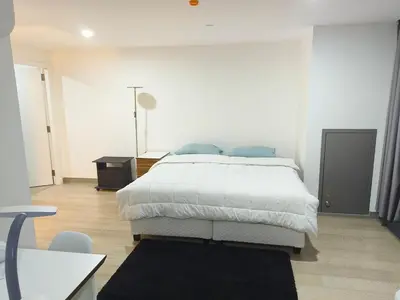 a white bedroom with a large bed in it at In the City in Manila