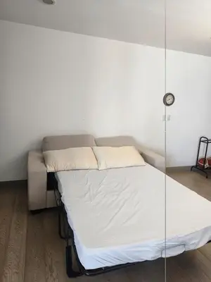 a bed in a room with a glass wall at In the City in Manila