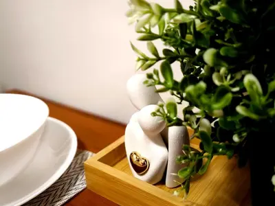 a wooden crate with a potted plant on a table at La Vie Riche Holiday Homes - Cozy 1BR Apartment near MOA in Manila