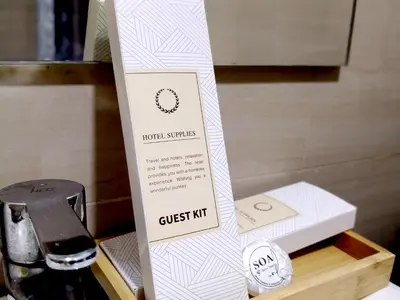a box of a guest kit next to a wii controller at La Vie Riche Holiday Homes - Cozy 1BR Apartment near MOA in Manila
