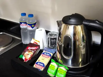 a tea kettle sitting on top of a counter at La Vie Riche Holiday Homes - Cozy 1BR Apartment near MOA in Manila