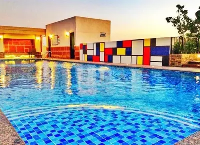a large swimming pool with colorful tiles on the side of a building at Morgan Suite Studio a7 next to VeniceCanal Mall Wi-fi in Manila