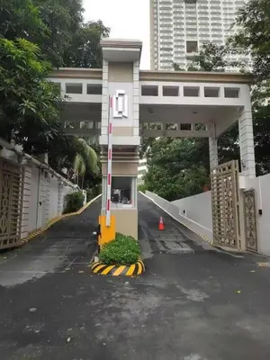 a bridge over a road with a building at Torre De Manila in Manila