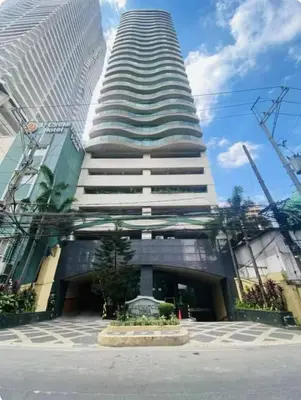 a tall building with a fountain in front of it at Seaview in Malate in Manila