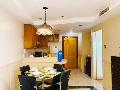 a dining room with a table and chairs in a kitchen at Seaview unit in Manila