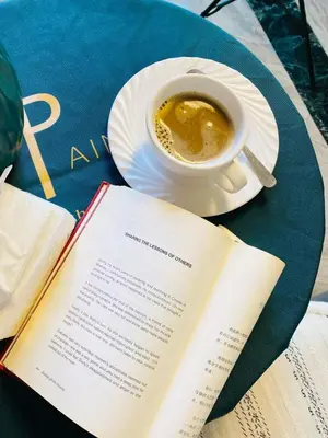 an open book and a cup of coffee on a table at Seaview unit in Manila
