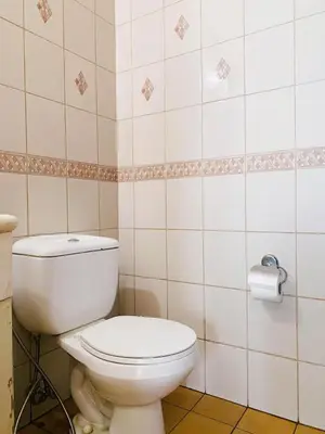 a bathroom with a toilet and a roll of toilet paper at Seaview unit in Manila