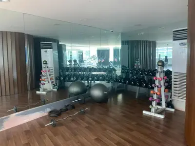 a gym with a mirror and some exercise equipment at Budget City View w Pool Access in BGC Taguig City in Manila