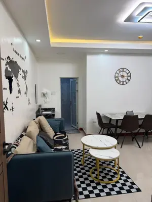 a living room with a blue couch and a table at JCAL Building Next to Manila Aiports Okada, Solaire MOA in Manila