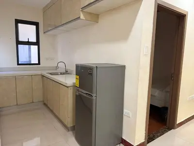a kitchen with a refrigerator and a sink at JCAL Building Next to Manila Aiports Okada, Solaire MOA in Manila