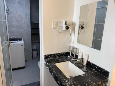 a bathroom with a sink and a mirror at JCAL Building Next to Manila Aiports Okada, Solaire MOA in Manila