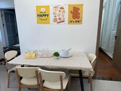 a dining room table with chairs and a sign that reads happy it is ok at JCAL Building Next to Manila Aiports Okada, Solaire MOA in Manila