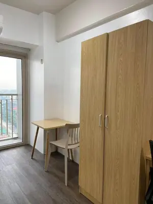 a room with a desk and a cabinet and a window at FX Property 3950 in Manila