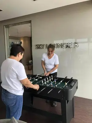 a man and a woman playing a game of chess at FX Property 3950 in Manila