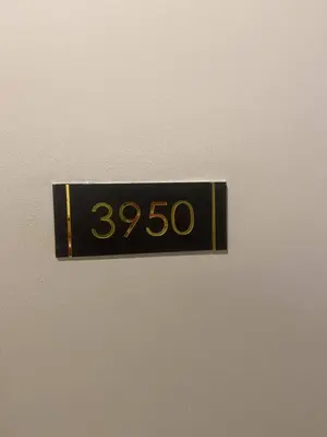 a black and gold clock on a wall at FX Property 3950 in Manila