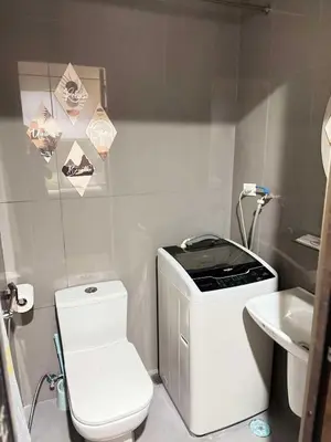 a small bathroom with a toilet and a sink at Comfortable & Peaceful for You #4806 in Manila