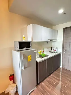 a kitchen with a refrigerator and a microwave at Comfortable & Peaceful for You #4806 in Manila