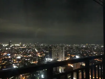 a view of a city at night with lights at Comfortable & Peaceful for You #4806 in Manila