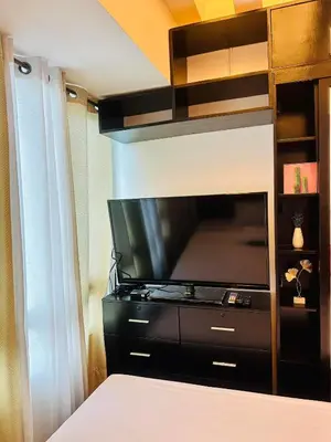 a large flat screen tv in a room at The Beacon Makati by Christine Suites PH in Manila