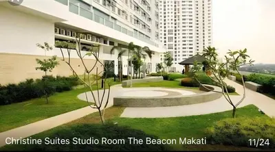 a building with a walkway in front of a building at The Beacon Makati by Christine Suites PH in Manila