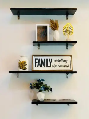 two shelves with plants and a sign on a wall at The Beacon Makati by Christine Suites PH in Manila