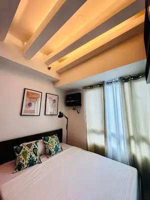 a bedroom with a bed with a white bedspread at The Beacon Makati by Christine Suites PH in Manila