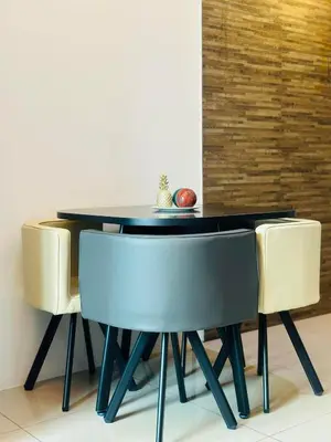 a black dining room table with two chairs and an apple on it at The Beacon Makati by Christine Suites PH in Manila