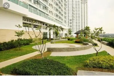 a building with a garden in front of a building at The Beacon Makati by Christine Suites PH in Manila