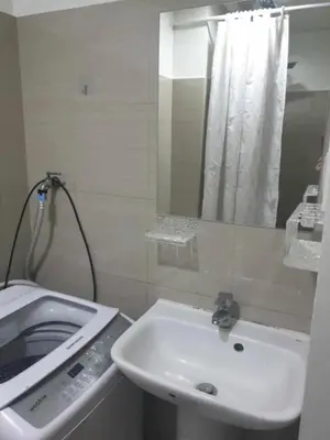 a bathroom with a sink and a mirror at Shore 2 tower 2 in Manila