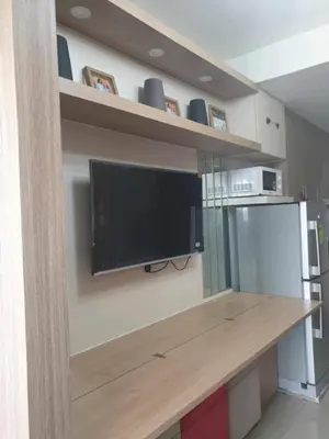 a kitchen with a flat screen tv on a wall at Shore 2 tower 2 in Manila