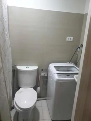 a small bathroom with a toilet and a sink at Shore 2 tower 2 in Manila