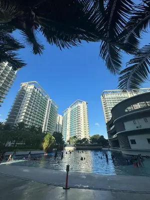 a view of buildings in a city with a pond at Apple Paris Azure Staycation in Manila