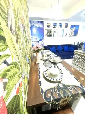 a table with two plates on top of it at Apple Paris Azure Staycation in Manila