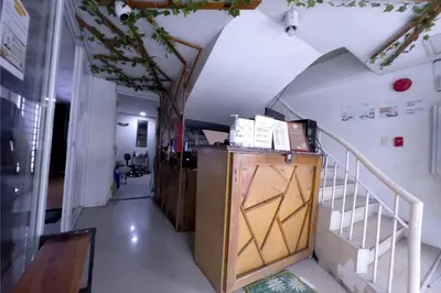a hallway with stairs and a wooden cabinet with a door at Jardin Oriental Suites Ubelt Manila in Manila