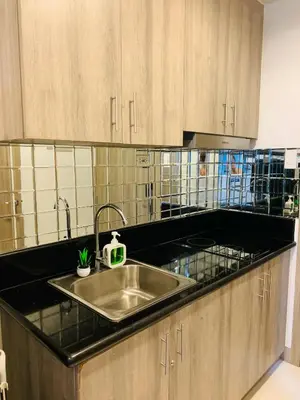 a kitchen with a sink and a counter top at CGS Crib staycation in Manila