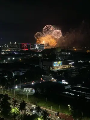 a firework display in a city at night at CGS Crib staycation in Manila
