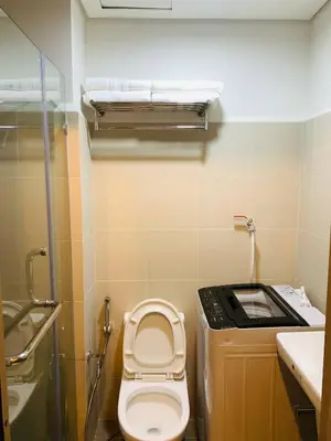 a small bathroom with a toilet and a sink at CGS Crib staycation in Manila