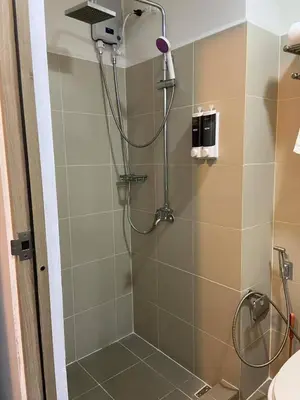 a shower with a shower head in a bathroom at FX Property 3926 in Manila