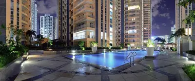 a swimming pool in a city with tall buildings at Awesome Sunset View in Venice Mall Suite with PS5 30th edition, Walk to Everything, 5 mins away to BGC, DisneyPlus, Prime Video, HBO Max in Manila