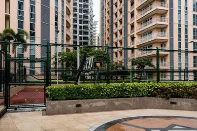 a courtyard in a city with tall buildings at Awesome Sunset View in Venice Mall Suite with PS5 30th edition, Walk to Everything, 5 mins away to BGC, DisneyPlus, Prime Video, HBO Max in Manila