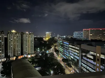 a view of a city at night with buildings at Awesome Sunset View in Venice Mall Suite with PS5 30th edition, Walk to Everything, 5 mins away to BGC, DisneyPlus, Prime Video, HBO Max in Manila